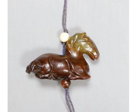 A Chinese green and brown jade ‘horse’ toggle. 4.5cm