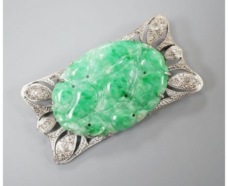 A white metal (stamped 9C?), diamond chips and oval carved jade set shaped rectangular brooch, 52mm, gross weight 13.1 grams.