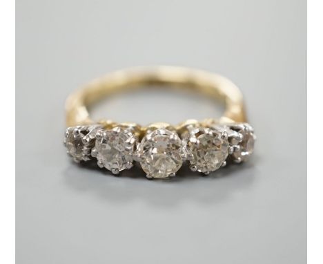 An 18ct and graduated five stone diamond set half hoop ring, size K, gross weight 4 grams.