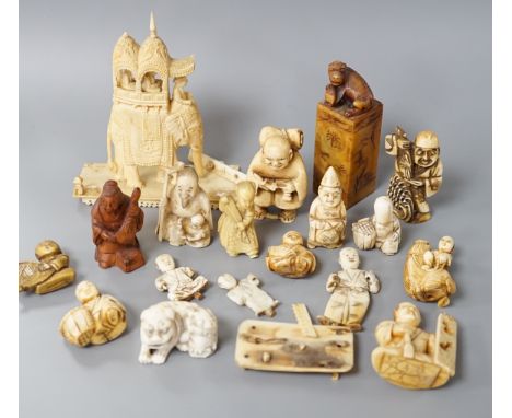 A collection of various ivory carvings including netsuke, a soapstone seal and carved wood netsuke