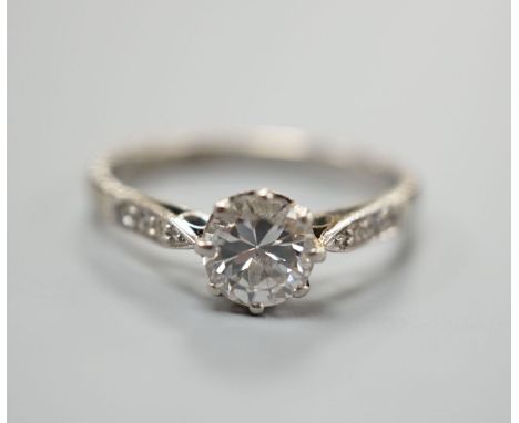 An 18ct and plat, single stone diamond ring, with diamond set shoulders, size O, gross weight  2.9 grams,the stone weighing a