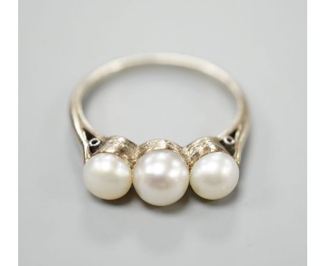 A white metal and three stone cultured pearl set ring, size M, gross weight 2.8 grams.