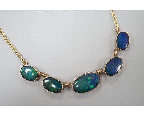 A yellow metal and graduated oval opal doublet set fringe necklace, 48cm, gross weight 14.1 grams.