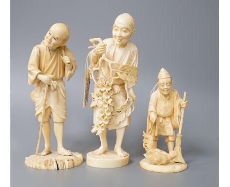 A 19th century Japanese ivory okimono of a gentleman holding a branch, another sectional figure of a gentleman with a walking