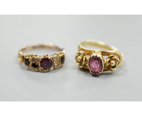 A Victorian gold, garnet and seed pearl set dress ring, size N/O and a yellow metal and garnet set ring, gross 5 grams.