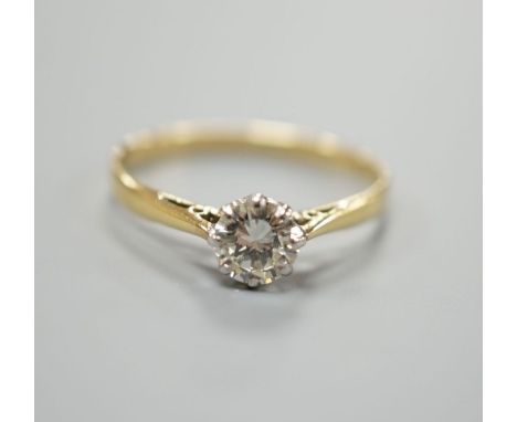 A yellow metal and simulated solitaire diamond ring, size O, gross weight 1.6 grams.