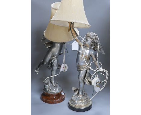 A pair of silvered metal cherub lamps in dancing pose bearing torch lamp, signed L. Gregoire