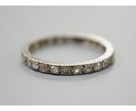 A white metal and diamond chip set full eternity ring, size M, gross weight 2.1 grams.