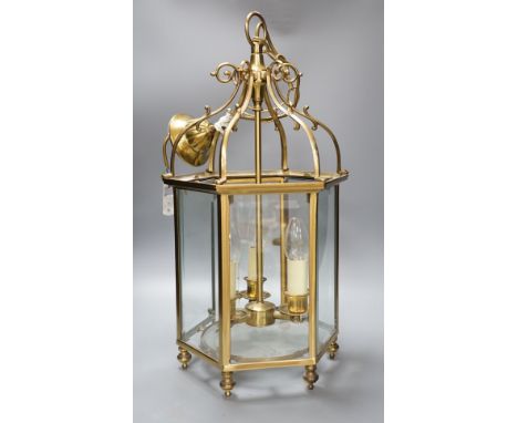 A three light brass hall lantern in hexagonal glass opening case - 56cm high excluding ceiling rose suspension