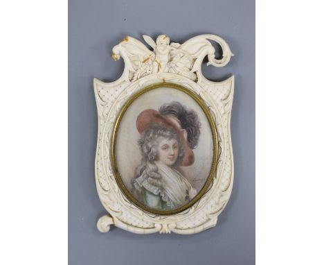 A 19th century carved ivory frame housing an indistinctly signed portrait miniature of a lady 14cm high.