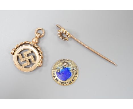 A 1920's pendant, 26mm, a yellow metal and split pearl set horseshoe stick pin and a damaged yellow metal and enamel pendant,