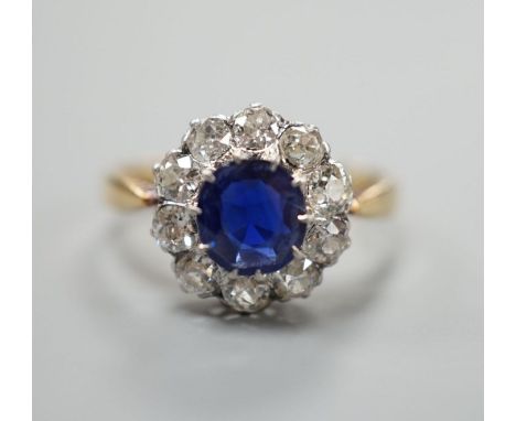 A yellow metal, sapphire and diamond set circular cluster ring, size N/O, gross weight 3.1 grams.