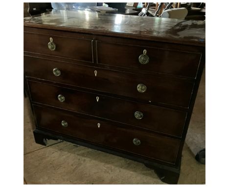 A George III mahogany chest of two long drawers and a fake panel of one long and two short graduated drawers,concealing a gre