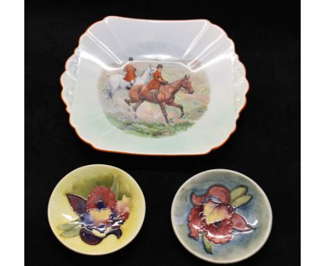 A Moorcroft orchid pattern pin dish and a similar example, both with impressed marks and paper labels, 11.5cm diam and a Shel