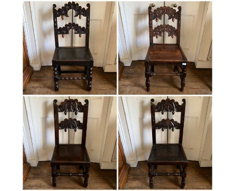 A matched set Charles II oak dining chairs, circa 1660-1680, arch splats with scrolling carving with acorn finials, two raise