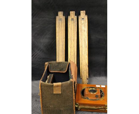 An Edwardian mahogany brass mounted folding plate camera, canvas case, on folding tripod stand