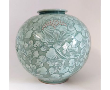 A Korean mid 20th centaury&nbsp;vase in jade green with a Celedon crackle glaze.
Decorated with chrysanthemum in a continues&