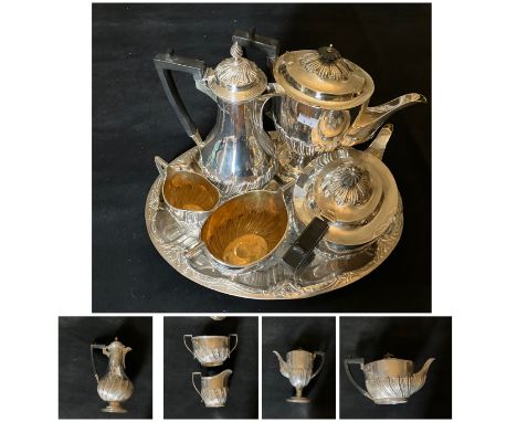 A George V five piece silver tea and coffee service of partly wrythen form comprising teapot and coffee pot with ebonized han