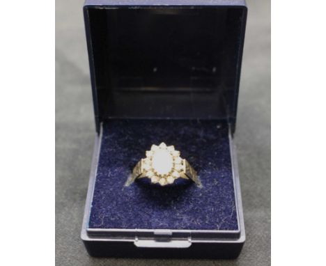 18ct yellow gold opal and diamond cluster ring.&nbsp;
Opal is approx 7mm height by approx 5mm width and has flashes of blue, 