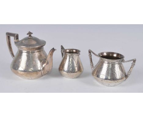 A Victorian silver three-piece bachelors tea set, comprising teapot, twin handled sugar, and milk jug, all with angular handl