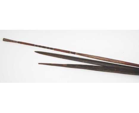 A hand carved black palm-wood ceremonial spear, the tip of flattened leaf shape with remains of polychrome decoration, 193cm,