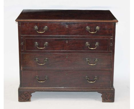 A George III mahogany bachelors' chest, having well-fitted top drawer with centre hinged mirror flanked by various lidded com