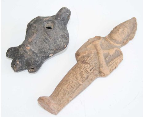 A pottery oil lamp, the body modelled as a head, having three spouts and pierced flattened handle, Greco-Roman, h.5cm, togeth