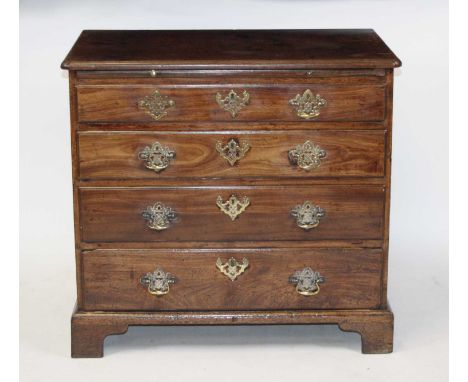 An early George III faded mahogany chest, the top having a moulded edge above a brushing slide and four long graduated drawer