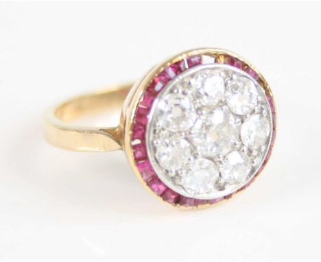 A yellow and white metal, ruby and diamond circular cluster ring, comprising eight Old European cut diamonds grain set within