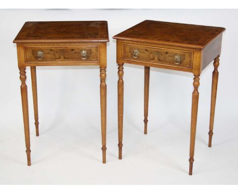 A pair of figured walnut and walnut lamp tables, each having four quarter veneered cross and feather banded tops above a sing