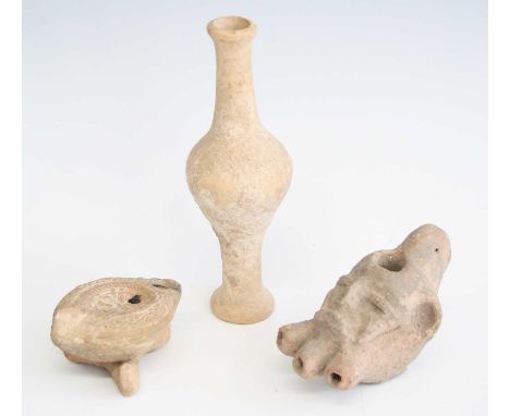 A pottery oil lamp, the body modelled as a head with three spouts and flattened handle, h.7cm, together with one other oil la