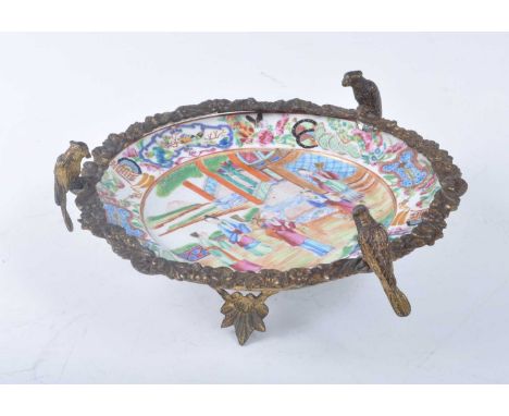A 19th century Chinese Canton porcelain dish, enamel decorated with figures, having later European gilt metal mounts, dia.22c