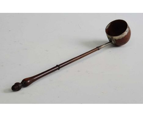 An 18th century toddy ladle, the coquilla nut bowl having silver mounts leading to a turned rosewood handle, l.30cmThe bowl i