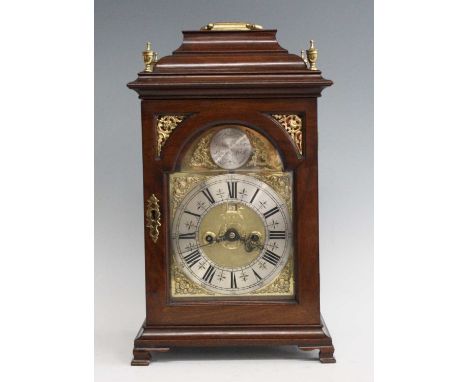 A mid-18th century walnut cased bracket clock, the case with caddy top and brass swing carry handle, over an arched brass dia