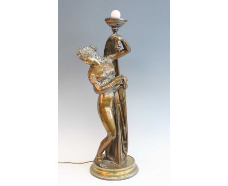 A circa 1900 lacquered brass figure of a robed maiden, standing upon an associated circular brass plinth, the whole drilled f