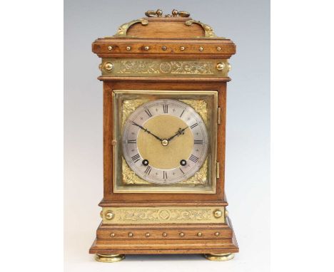 A late 19th century walnut cased mantel clock by Winterhalder &amp; Hofmeier, the case with brass mounts, the dial having sil