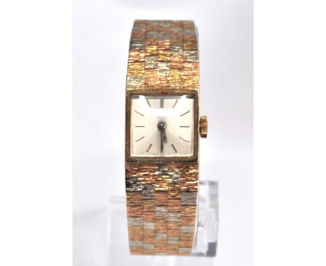 A 9ct rose, white and yellow gold lady's Bueche Girod manual wind wristwatch, having square cream baton dial and fitted to an