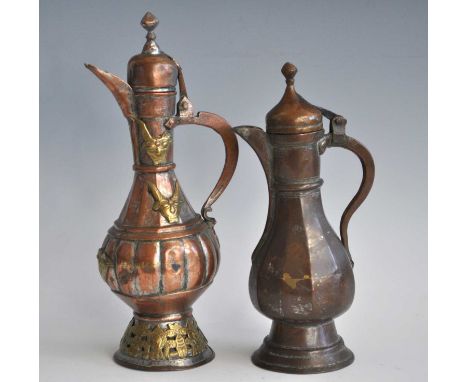 An Islamic copper butter teapot, having a domed cover above a fluted globular body and domed foot with applied brass mask dec
