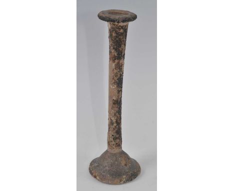 An Egyptian / Roman tall candlestick unguentarium glass vessel, having a flared circular rim to a slender neck and domed base