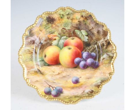 A Royal Worcester porcelain low comport, decorated with fruit on a mossy bank by T Lockyer, signed, all within a gilt border,