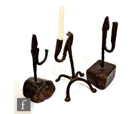 Two 17th/18th Century rush light holders, each mounted on a block, height 22cm, and a single holder on four splayed pad feet,