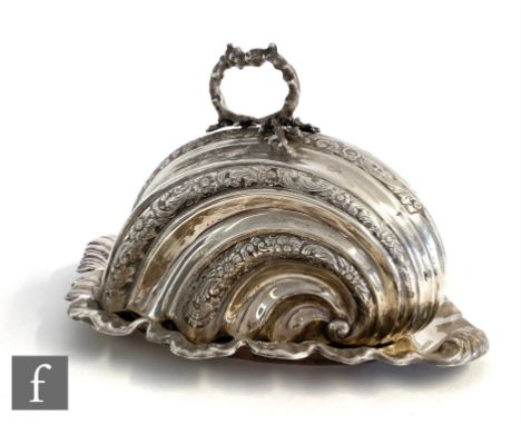 A hallmarked silver cheese dish and cover, the cushioned triangular base with scalloped border below a stylised nautilus shel