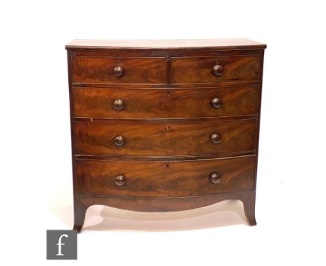 A 19th Century mahogany bow-fronted chest of two short over three long cock-beaded drawers with turned handles, raised to bra