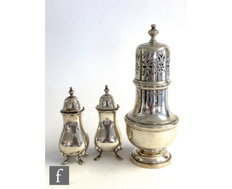 A silver hallmarked sugar sifter of ribbed baluster form with pierced pull off cover and finial, all above a circular spread 