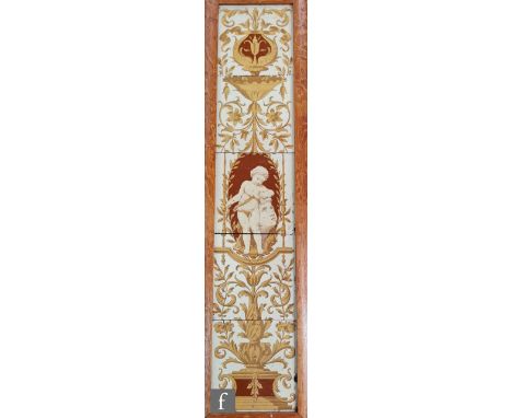 An early 20th Century framed tile panel comprising five 6in tiles decorated with a cherub carving a head, framed with classic