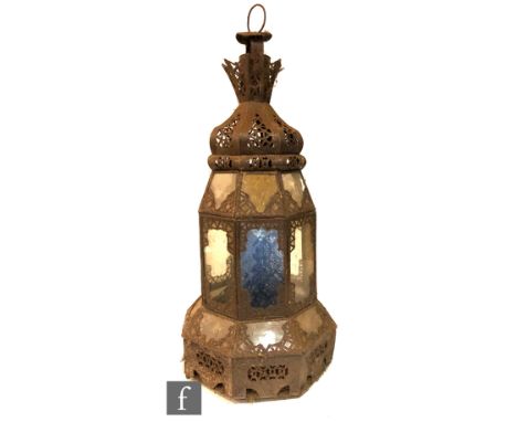An iron garden candle light fitting with coloured glass panels with suspension loop, height 62cm, S/D. 
