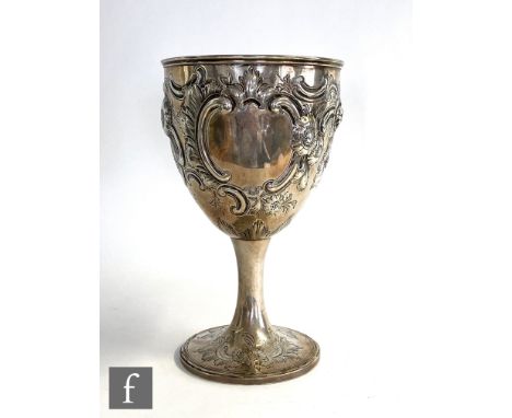 A Georgian hallmarked silver goblet later decorated with embossed flowers and scrolls, height 23cm, weight 16.5oz, London 180