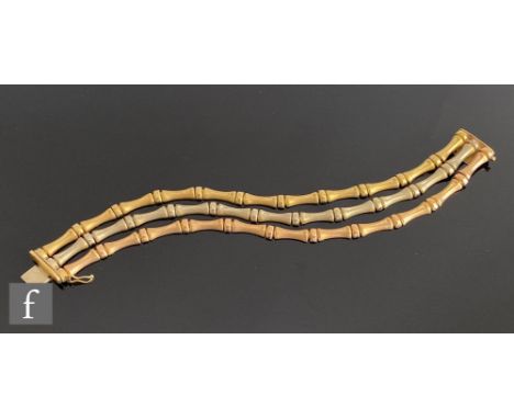 An 18ct hallmarked three strand bracelet comprising rose, white and yellow gold articulated rows of waisted panels terminatin