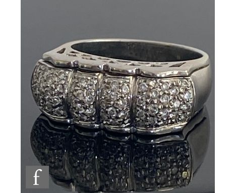 An 18ct white gold diamond ring, the four pave set domed sections to a cushioned rectangular head, weight 10.5g, ring size N.