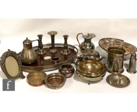 A parcel lot of assorted silver plated items to include a wooden base tray, bottle coasters, candle sticks, a four piece tea 